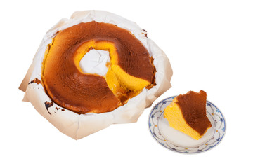Pao de Lo, the Portuguese sponge cake shown in its most traditional form, with the typical paper sheets used on the baking, isolated on white background