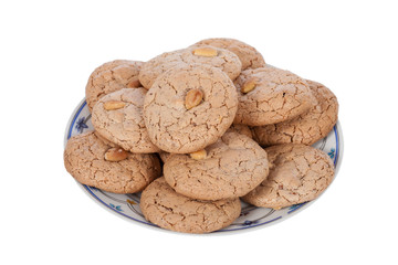 Almendrados, a typical and traditional almond biscuit from the Algarve region of Portugal, on a plate and isolated on white background