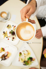 coffee cup in nahd at table