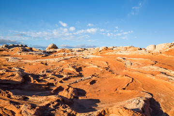 Bright orange sandstone mixed with white layers at sunrise