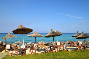 straw umbrella on a beach near the sea.  Halkidiki, Greece