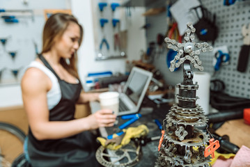 Concentrated female mechanic having rest in the repair shop