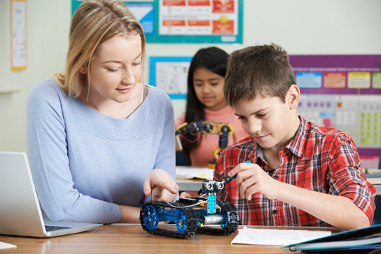 Teacher With Pupils In Science Lesson Studying Robotics