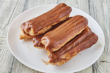 Homemade eclairs with cream and chocolate topping