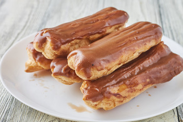Homemade eclairs with cream and chocolate topping