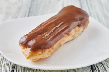 Homemade eclairs with cream and chocolate topping