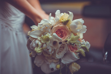 bright wedding bouquet in hands of bride
