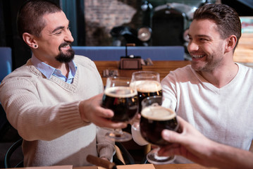 Selective focus of nice cheerful men looking at each other