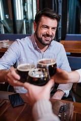 Handsome bearded man cheering with his friends