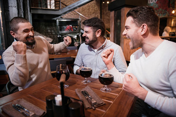 Positive delighted men expressing their emotions