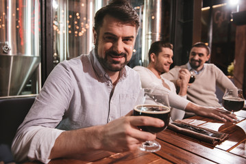 Handsome pleasant man enjoying his drink
