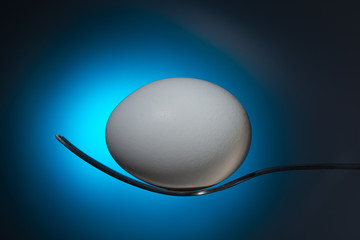 egg on a fork on a blue background

