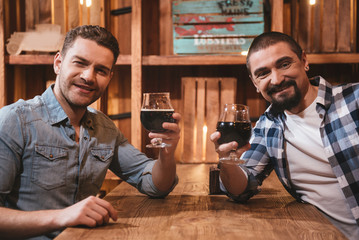 Pleasant joyful men resting after work
