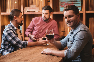 Positive joyful man sitting at the table