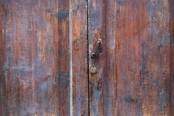 Vintage wooden door with iron handle and lock