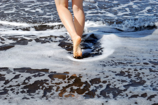 Beautiful female legs and black sand beaches