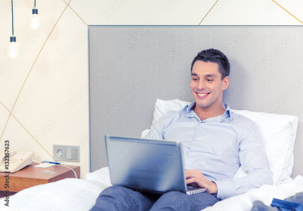 Sticker happy businesswoman with laptop in hotel room