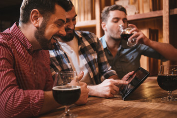 Positive nice man looking at the tablet screen