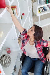 handicapped woman reaching for a book