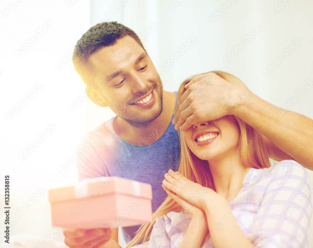 Sticker smiling man surprises his girlfriend with present