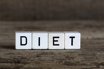 Diet, written in cubes on wooden background