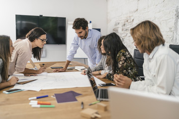 Young team of coworkers making great work discussion in a studio