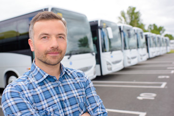 posing with a row of buses
