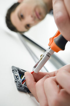 Man cutting wires in a plug