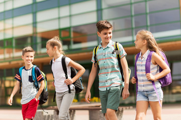 group of happy elementary school students walking