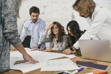 Young team of coworkers doing a brainstorming in a modern studio