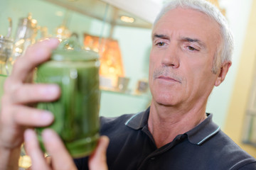 Man looking at antique pot