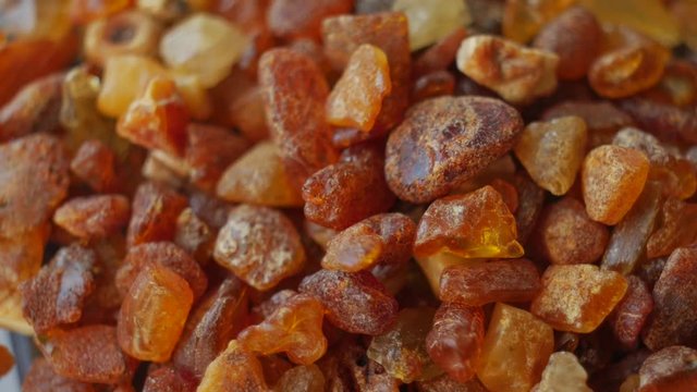 Amber stone macro rotate. Baltic gold. Small pieces. Slow motion