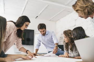 Young team of coworkers doing a brainstorming in a modern studio