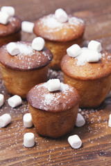 muffins with marmalade on wooden background