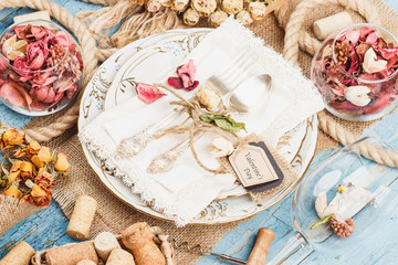 Fototapeta na wymiar Tableware and silverware with dry flowers