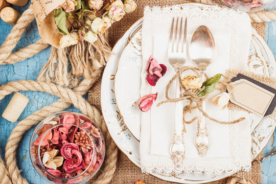 Tableware and silverware with dry flowers