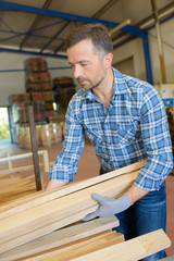 sawmill employee working with wood tools and machinery