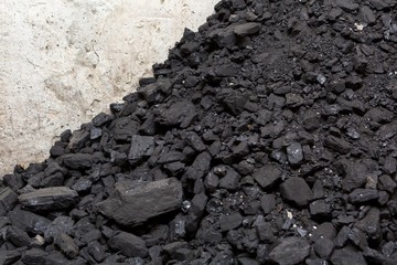 Black coal lying on a pile in house basement