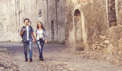 Couple of young travelers walking around old town
