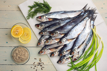 Raw river fish sabrefish on white paper