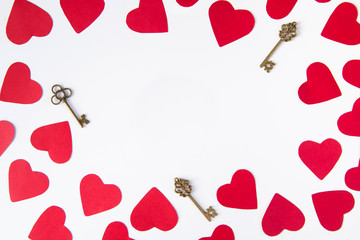 Composition frame of red hearts and keys on a white background - a romantic pattern on Valentine's Day
