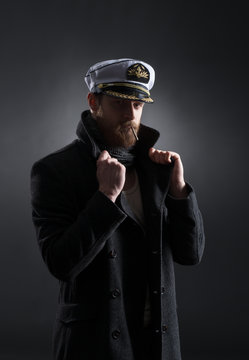 Portrait of a handsome sailor on a dark background