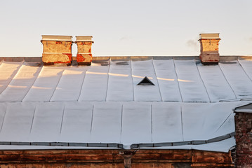 Old town roof in winter. Snow and frost in center city.
