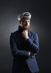 Portrait of a handsome sailor on a dark background