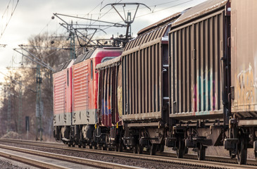 german cargo train drives on tracks to freight yard