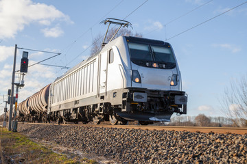 Naklejka premium german cargo train drives on tracks to freight yard