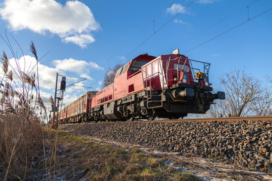 Fototapeta german cargo train drives on tracks to freight yard