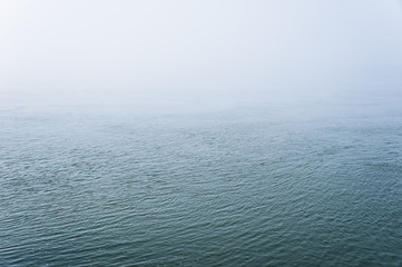 Water surface covered with fog.