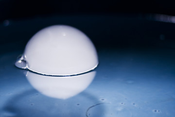 Abstract shot with big soap bubbles on a water surface with smoke inside

