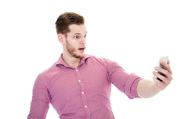 Amazed man looking on smartphone isolated on a white background